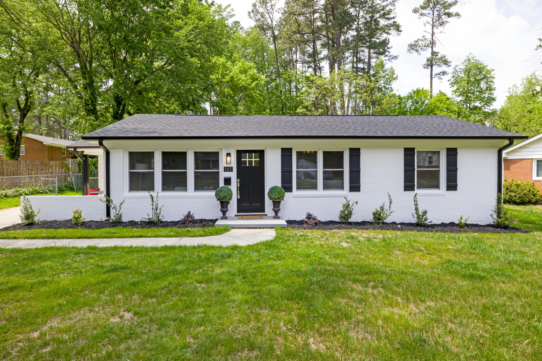Well-kept residential home with a manicured lawn and layered landscape beds